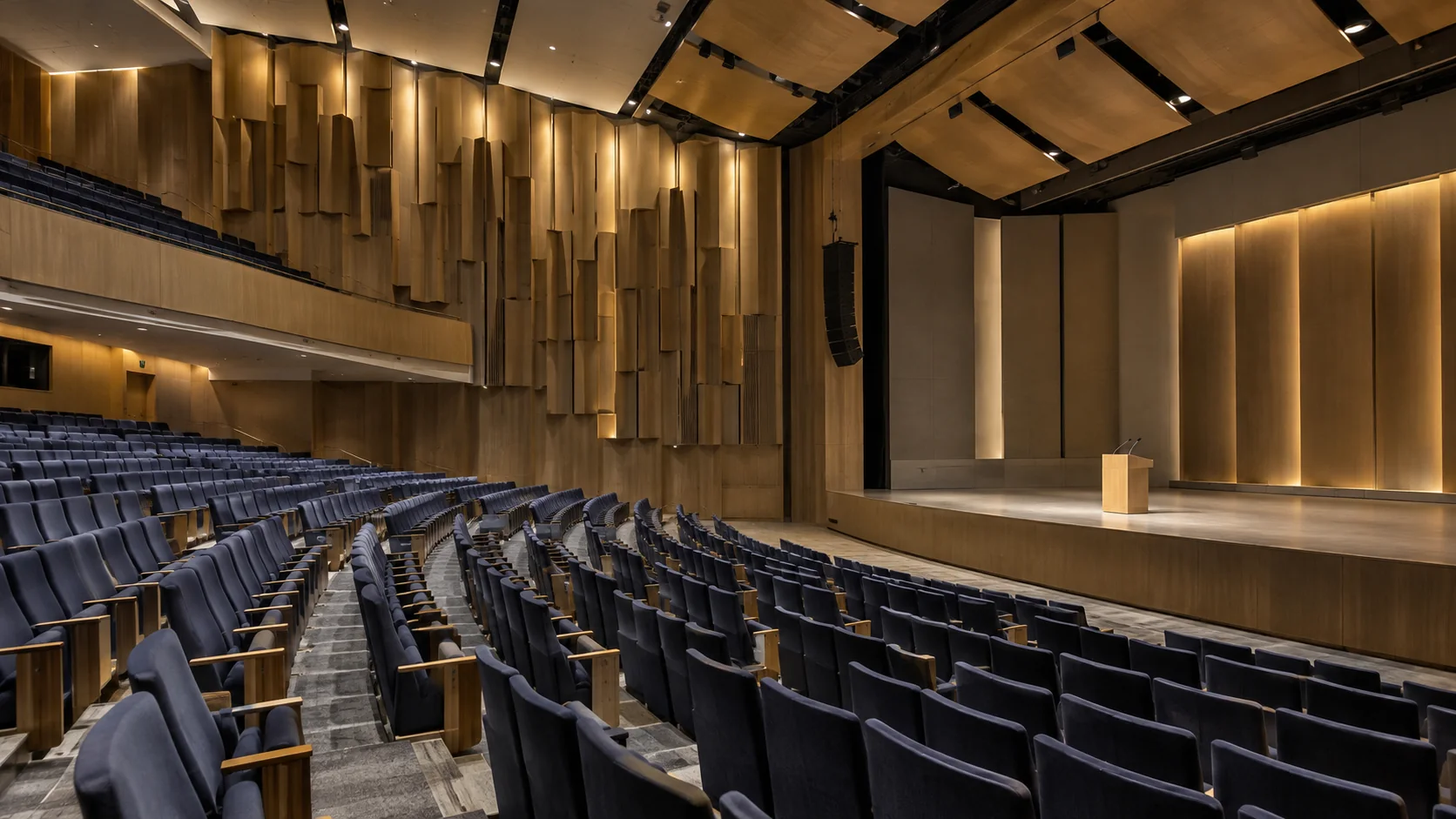 Auditorium with sculpted timber acoustic diffusers and overhead reflectors